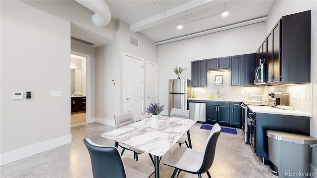 dining space with concrete flooring, a high ceiling, visible vents, baseboards, and beam ceiling