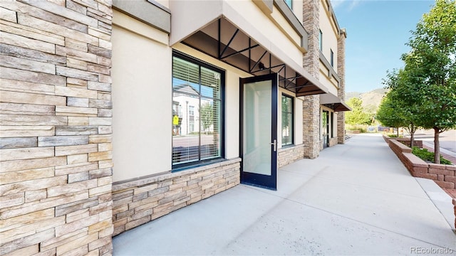 exterior space with stone siding