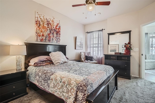 carpeted bedroom with ceiling fan and connected bathroom