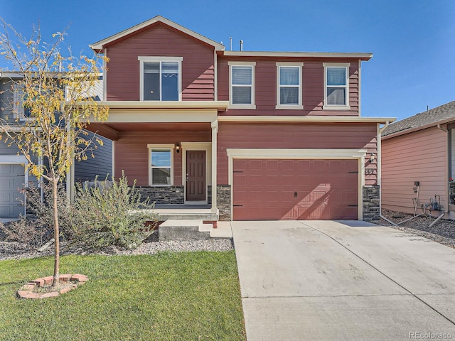 view of front of home featuring a front yard and a garage