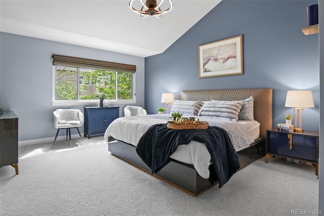 carpeted bedroom featuring vaulted ceiling and baseboards