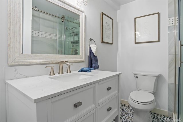 full bath with a stall shower, vanity, and toilet