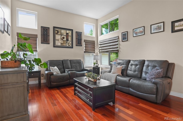 living room featuring dark wood-style floors and baseboards
