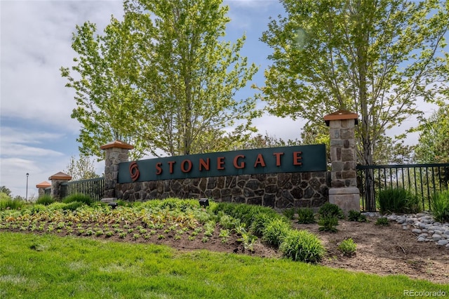 community / neighborhood sign featuring fence