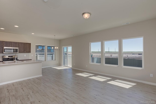 814 N Bently St, Watkins, CO 80137 - kitchen featuring appliances with stainless steel finishes, light wood-style flooring, light countertops, and recessed lighting
