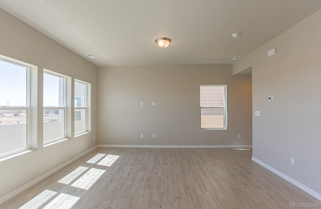 814 N Bently St, Watkins, CO 80137 - spare room with light wood-style flooring, baseboards, and a smoke detector