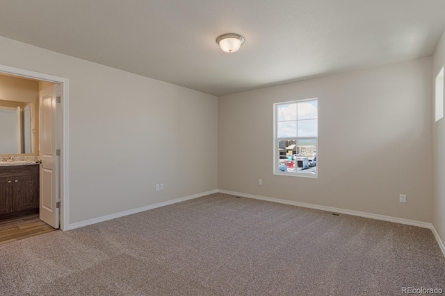 814 N Bently St, Watkins, CO 80137 - unfurnished room featuring light colored carpet, baseboards, and a sink