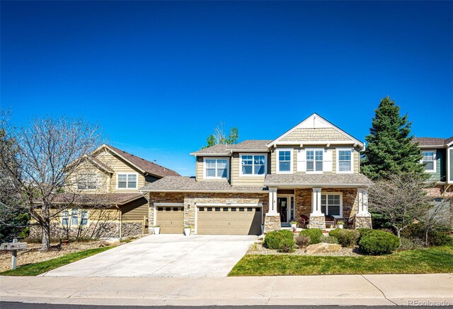 craftsman-style house featuring driveway, a porch, a garage, and stone siding