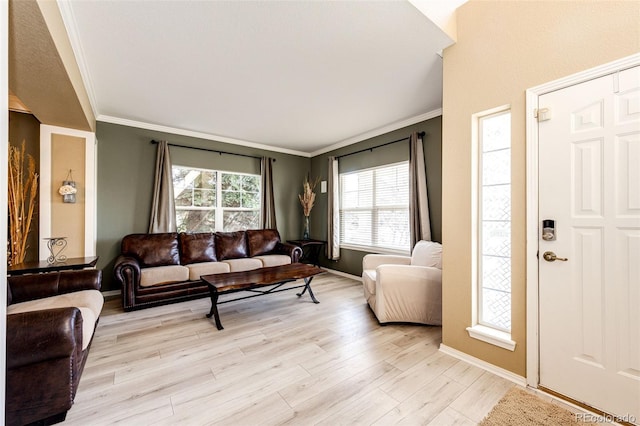 living room featuring crown molding, light wood-type flooring, and baseboards