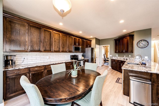 dining room with light wood-style floors and recessed lighting