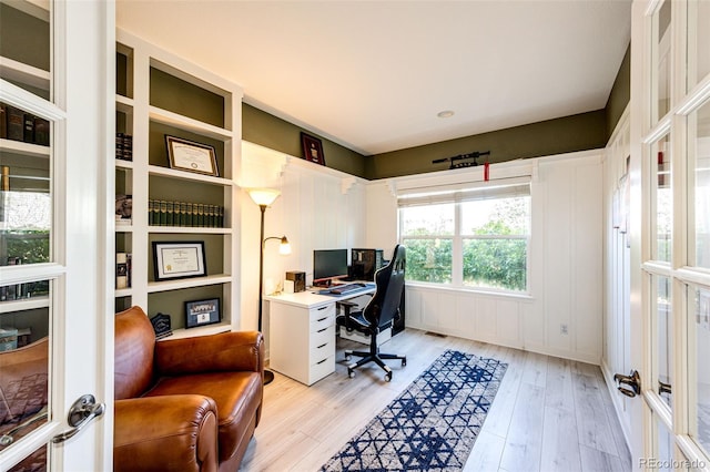 office space with light wood-type flooring and french doors