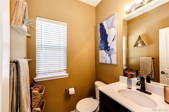 bathroom with toilet and vanity