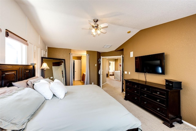 bedroom with light carpet, lofted ceiling, ceiling fan, and a textured wall