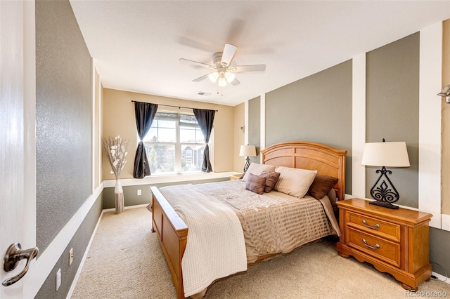 bedroom featuring light carpet, ceiling fan, and baseboards