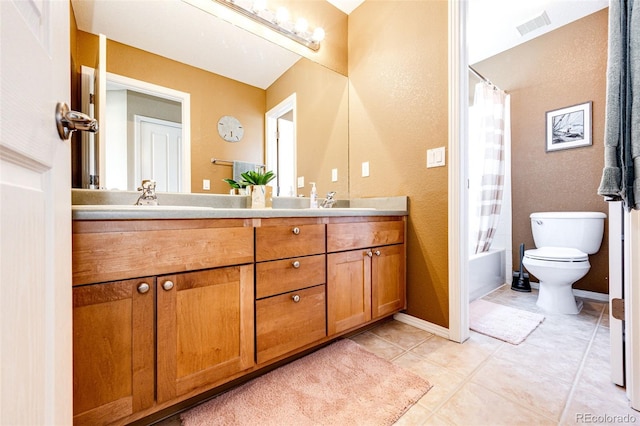 bathroom with toilet, double vanity, tile patterned floors, shower / bath combo, and a textured wall