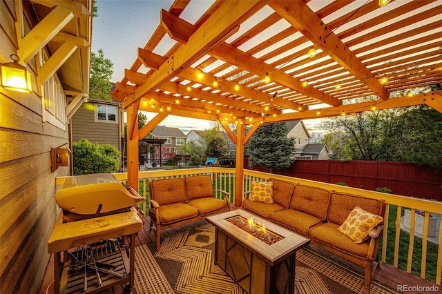 wooden terrace with an outdoor living space with a fire pit, fence, and a pergola