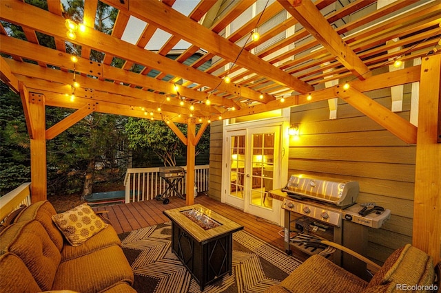 wooden deck featuring an outdoor living space with a fire pit, french doors, and a pergola