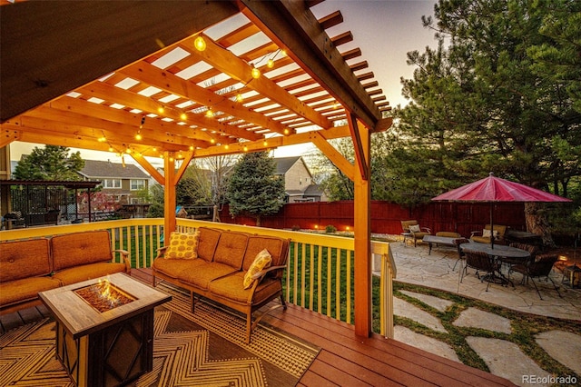 wooden deck featuring an outdoor living space with a fire pit, fence, a pergola, and a patio