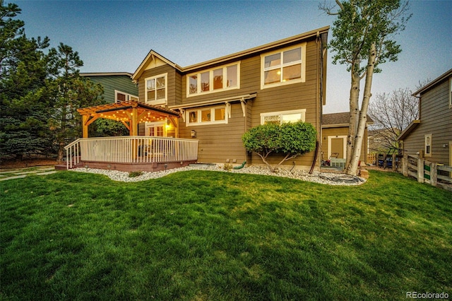 rear view of house with a wooden deck and a pergola