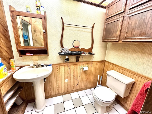 bathroom featuring wainscoting, wallpapered walls, and tile patterned flooring