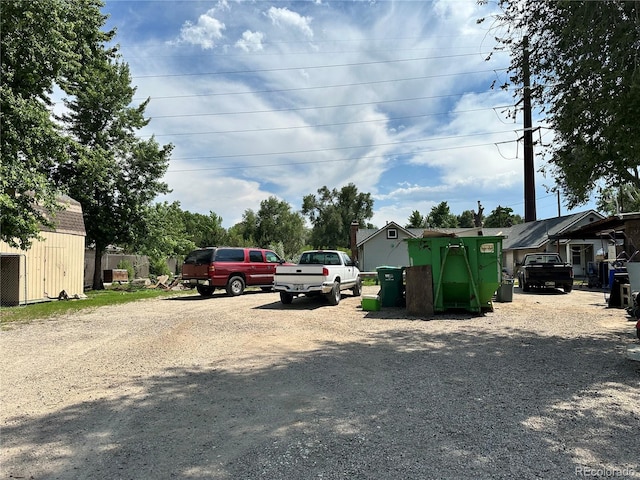 view of parking / parking lot featuring gravel driveway