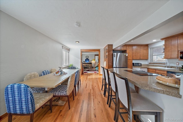 dining space featuring sink and light hardwood / wood-style flooring