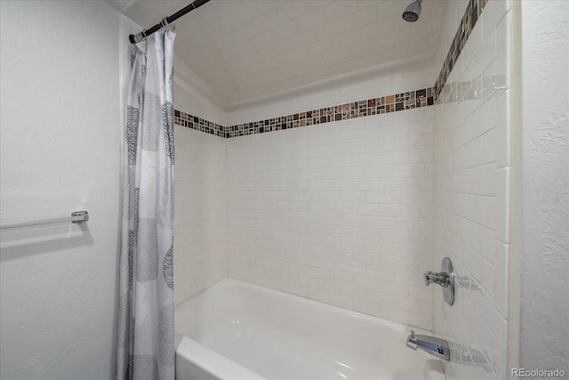 bathroom with shower / bath combo with shower curtain