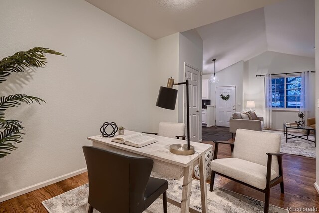 home office featuring lofted ceiling, dark wood-style floors, and baseboards