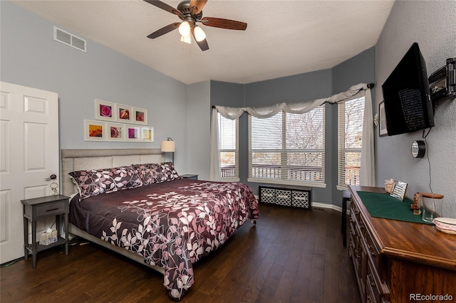 bedroom with wood-type flooring, visible vents, and a ceiling fan