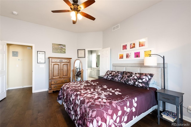 bedroom featuring wood finished floors, a ceiling fan, visible vents, baseboards, and ensuite bath