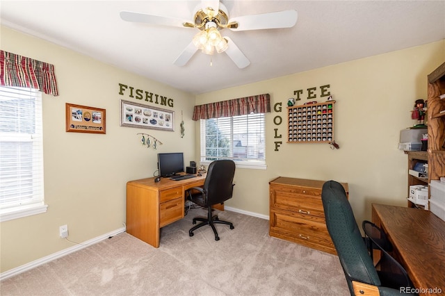 home office featuring ceiling fan, baseboards, and light colored carpet