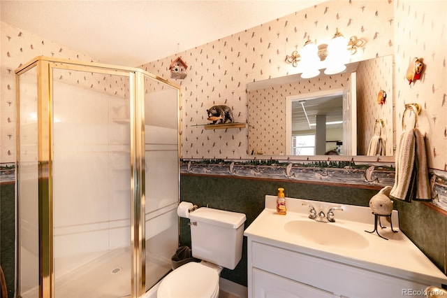 full bath with wallpapered walls, a stall shower, and vanity