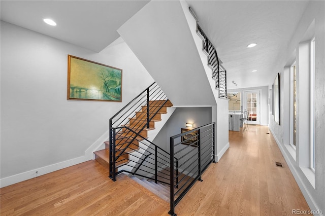 staircase with wood-type flooring