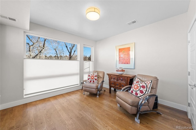 living area with hardwood / wood-style flooring