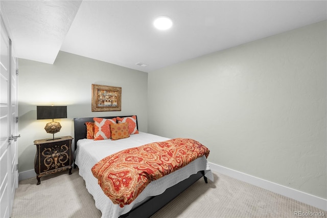 bedroom featuring light carpet