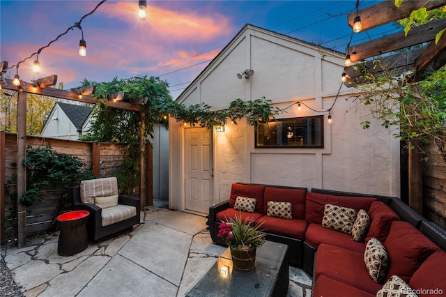 patio terrace at dusk featuring a pergola and outdoor lounge area