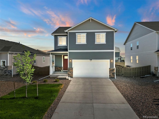 front of property with a lawn and a garage