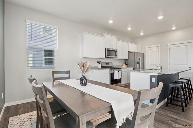 dining area with dark hardwood / wood-style flooring and sink