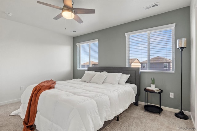 bedroom with light carpet and ceiling fan