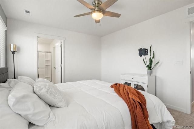 carpeted bedroom featuring ensuite bathroom and ceiling fan