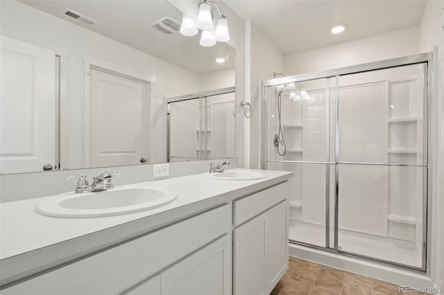 bathroom with vanity and a shower with door