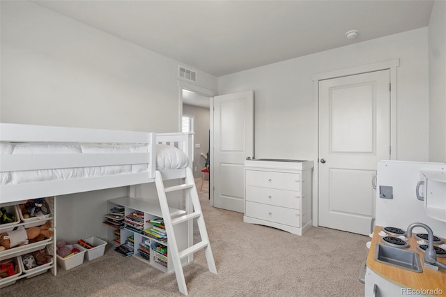 bedroom featuring light colored carpet