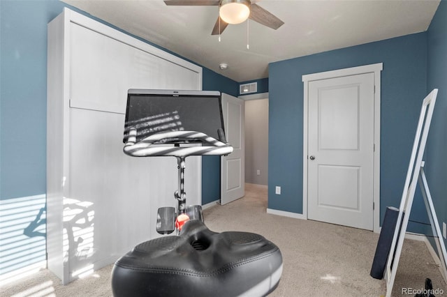 exercise room with ceiling fan