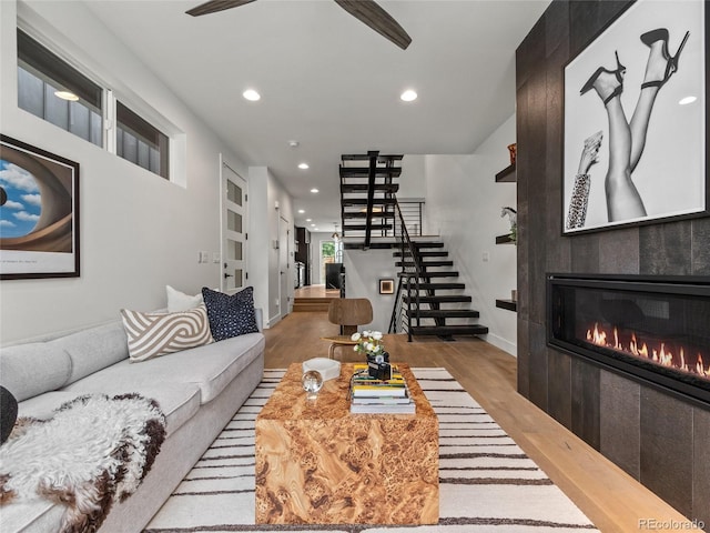 3715 Kalamath St, Denver, CO 80211 - living room featuring stairs, wood finished floors, recessed lighting, a tiled fireplace, and a ceiling fan