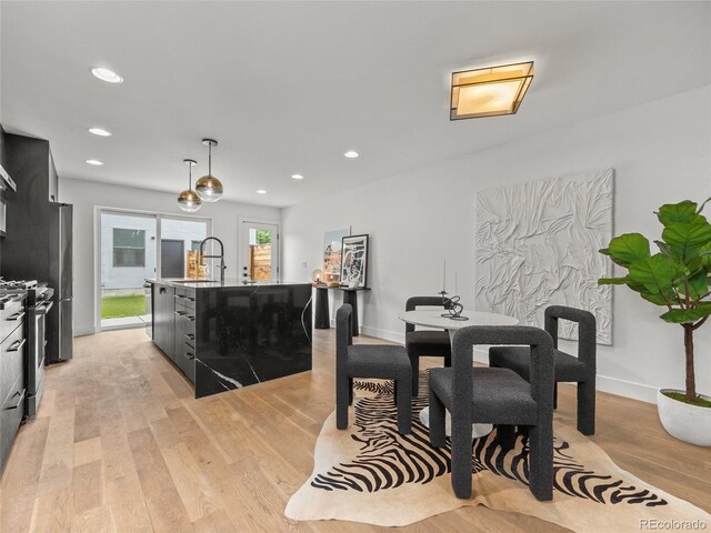 3715 Kalamath St, Denver, CO 80211 - dining space featuring light wood finished floors, recessed lighting, and baseboards
