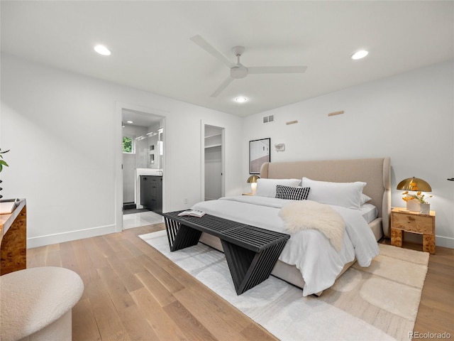 3715 Kalamath St, Denver, CO 80211 - bedroom with light wood-style floors, baseboards, recessed lighting, and a walk in closet