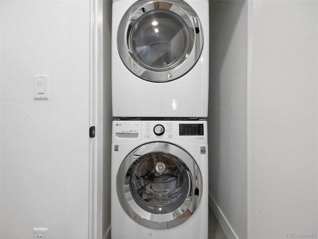 3715 Kalamath St, Denver, CO 80211 - washroom with stacked washing machine and dryer and baseboards