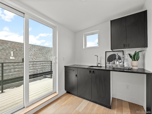 3715 Kalamath St, Denver, CO 80211 - kitchen with a sink, dark countertops, light wood-type flooring, dark cabinets, and vaulted ceiling