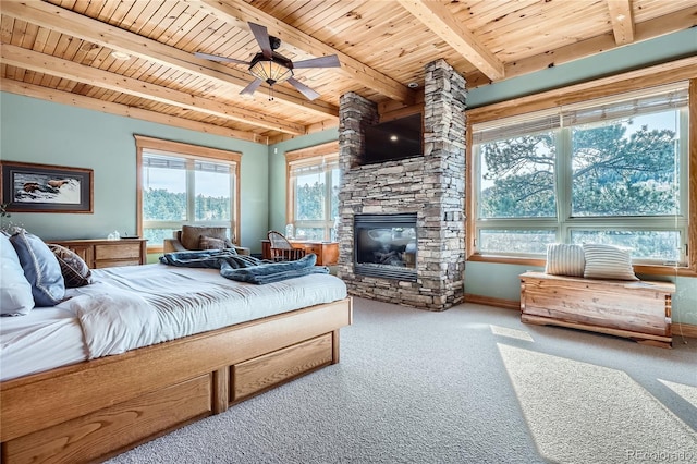 9659 S Turkey Creek Rd, Morrison, CO 80465 - carpeted bedroom with wooden ceiling with exposed beams, a fireplace, baseboards, and ceiling fan