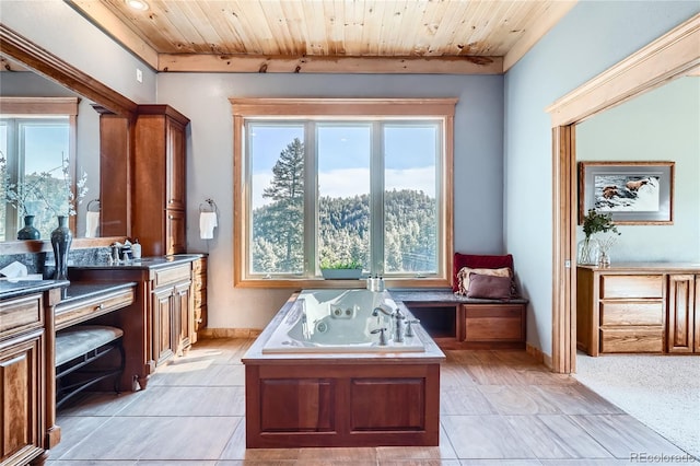9659 S Turkey Creek Rd, Morrison, CO 80465 - bathroom featuring vanity, a jetted tub, wood ceiling, plenty of natural light, and baseboards